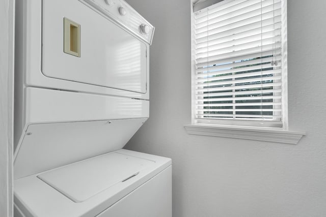 laundry room featuring stacked washing maching and dryer and laundry area