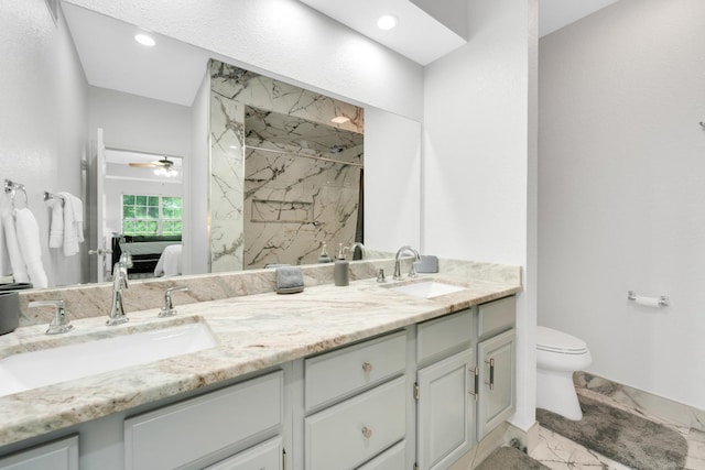 full bath with a sink, a marble finish shower, marble finish floor, and ensuite bath
