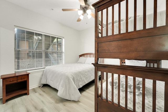 bedroom featuring baseboards and wood finished floors
