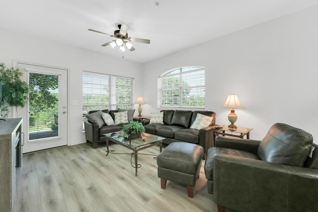 living area with light wood-type flooring and a ceiling fan