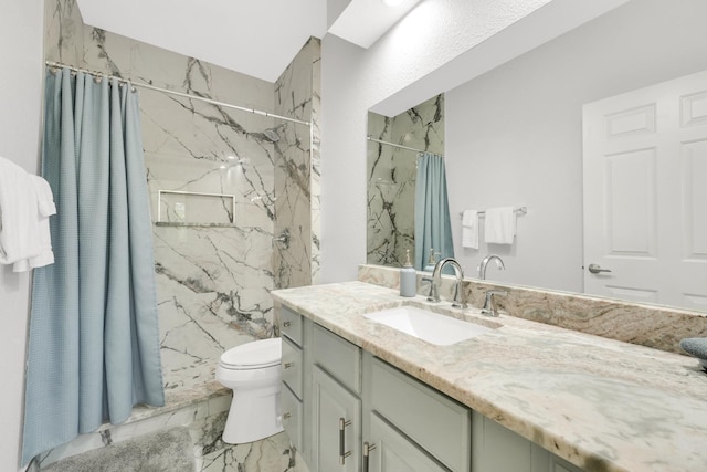 bathroom featuring vanity, marble finish floor, toilet, and a marble finish shower