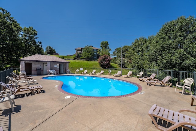 pool featuring a patio area and fence
