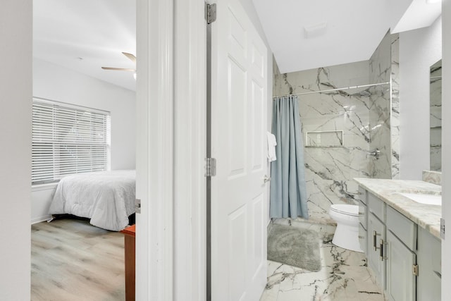 bathroom featuring vanity, ensuite bathroom, toilet, a marble finish shower, and ceiling fan