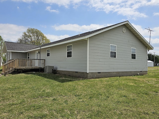 back of property featuring a shingled roof, crawl space, a lawn, and a wooden deck