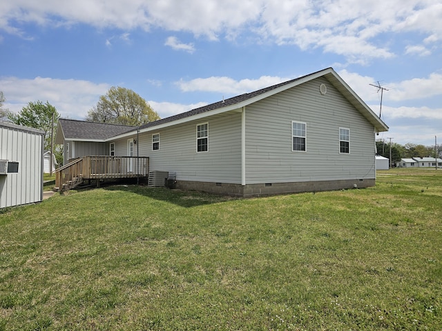 rear view of property with a lawn, a wooden deck, crawl space, and central air condition unit