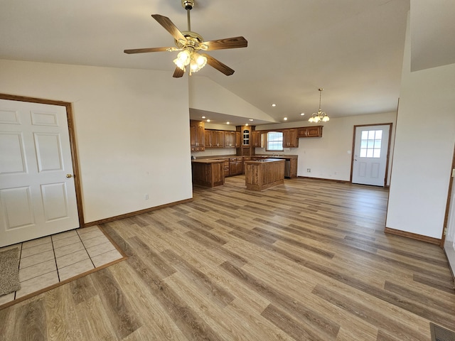 unfurnished living room featuring lofted ceiling, baseboards, visible vents, and light wood-style floors