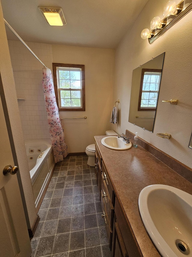 bathroom with a combined bath / shower with jetted tub, a sink, double vanity, and toilet