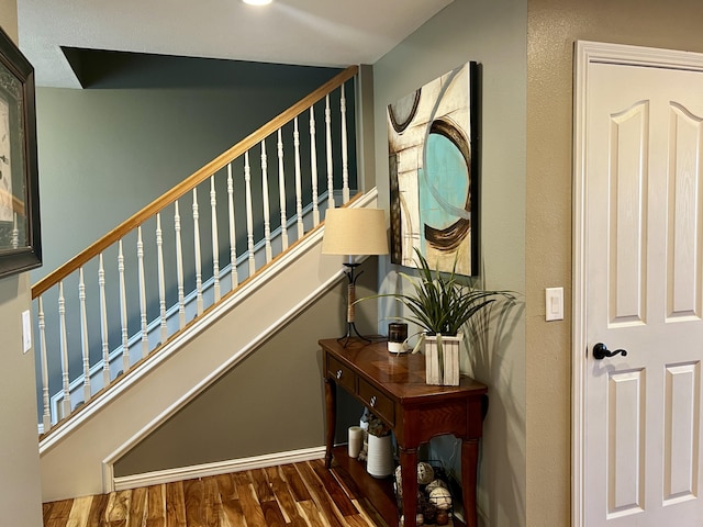 stairway with wood finished floors