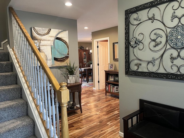 staircase featuring recessed lighting and wood finished floors