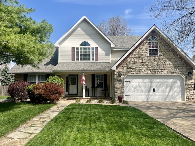 traditional-style home with a porch, roof with shingles, concrete driveway, and a front yard