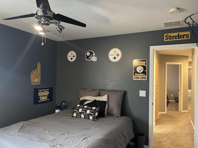 bedroom featuring visible vents, baseboards, a ceiling fan, and carpet