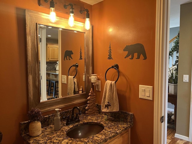 bathroom with wood finished floors and vanity