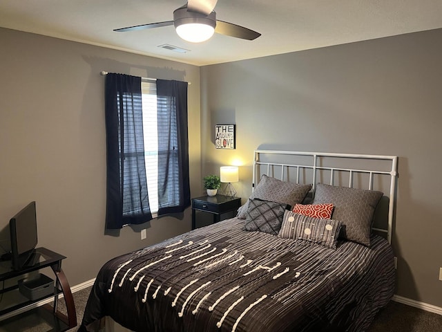 carpeted bedroom featuring visible vents, baseboards, and ceiling fan