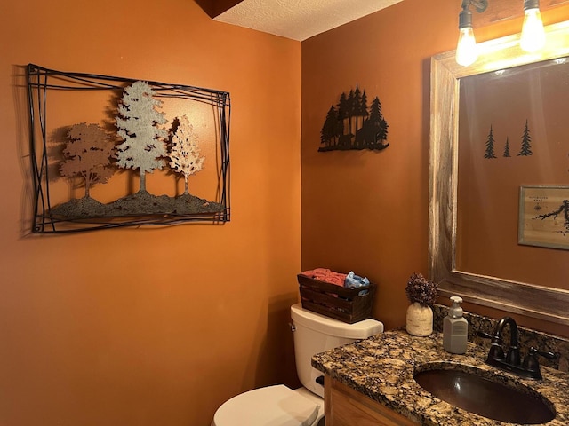 bathroom featuring toilet and vanity