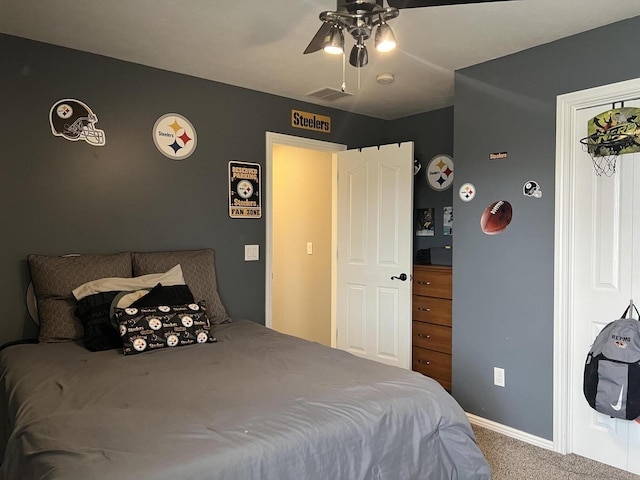 carpeted bedroom with baseboards, a ceiling fan, and visible vents