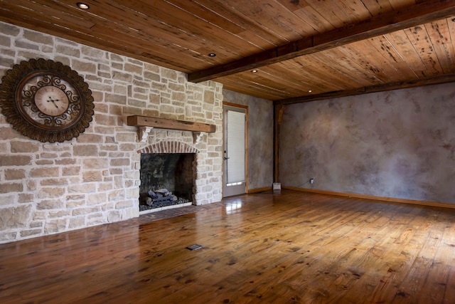 unfurnished living room with wooden ceiling, beamed ceiling, wood-type flooring, and a fireplace