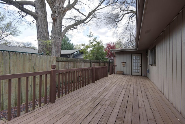 wooden terrace featuring fence