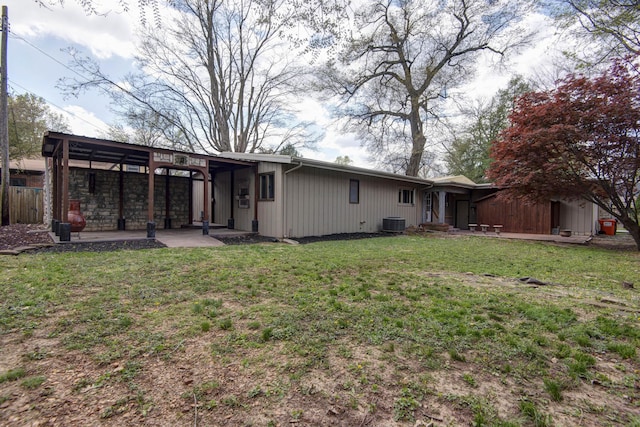 back of house with central AC unit, fence, a patio, and a lawn