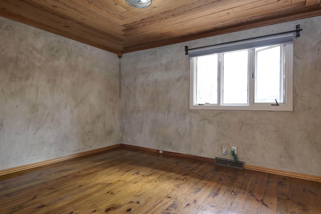 unfurnished room with visible vents, hardwood / wood-style flooring, baseboards, and wood ceiling
