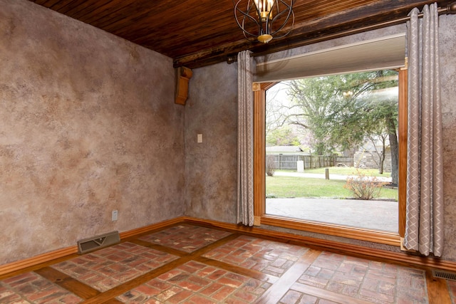 interior space featuring brick floor, visible vents, and wooden ceiling