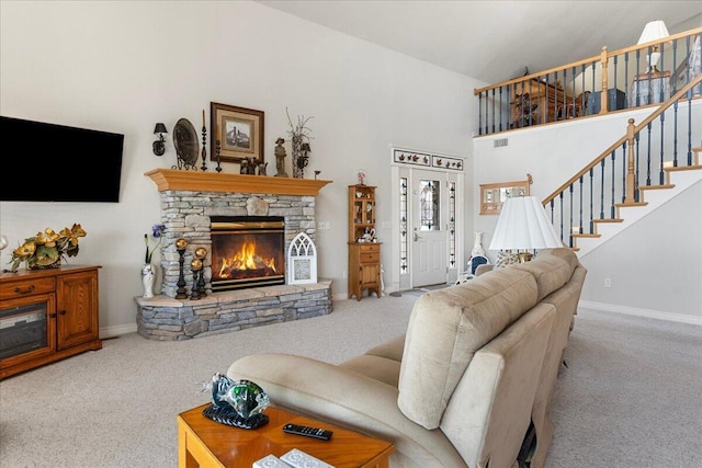 500 Navajo Trl, Kimberling City, MO 65686 - carpeted living area featuring a fireplace, visible vents, baseboards, and stairs