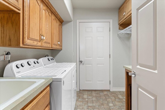 500 Navajo Trl, Kimberling City, MO 65686 - laundry area with stone finish flooring, washer and dryer, baseboards, and cabinet space