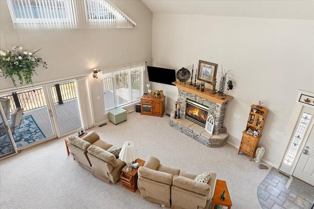 500 Navajo Trl, Kimberling City, MO 65686 - carpeted living area with high vaulted ceiling, visible vents, a stone fireplace, and baseboards