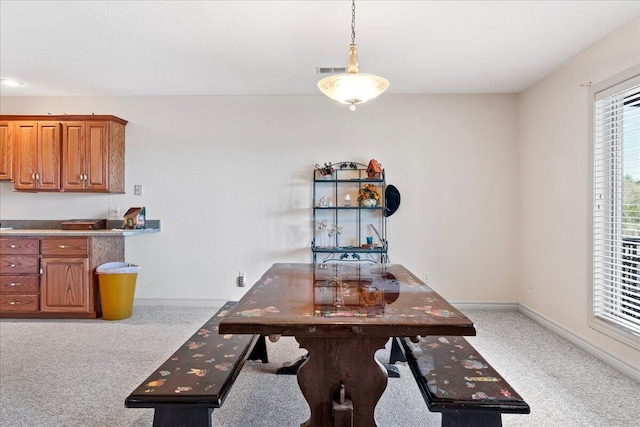 500 Navajo Trl, Kimberling City, MO 65686 - dining space featuring light colored carpet, baseboards, and visible vents
