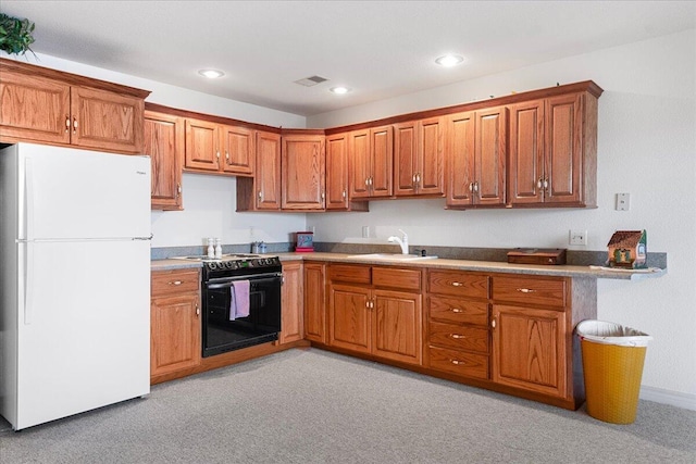 500 Navajo Trl, Kimberling City, MO 65686 - kitchen with a sink, freestanding refrigerator, brown cabinetry, black electric range, and light colored carpet
