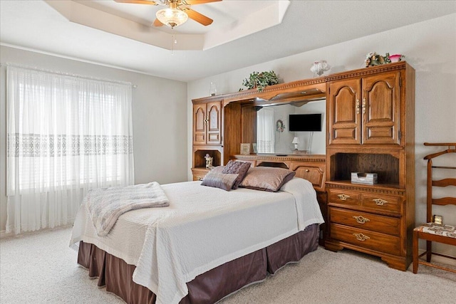 500 Navajo Trl, Kimberling City, MO 65686 - bedroom featuring a raised ceiling, light carpet, and a ceiling fan