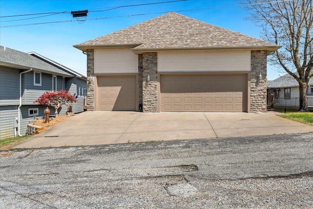 500 Navajo Trl, Kimberling City, MO 65686 - view of front facade with a garage, driveway, stone siding, and a shingled roof