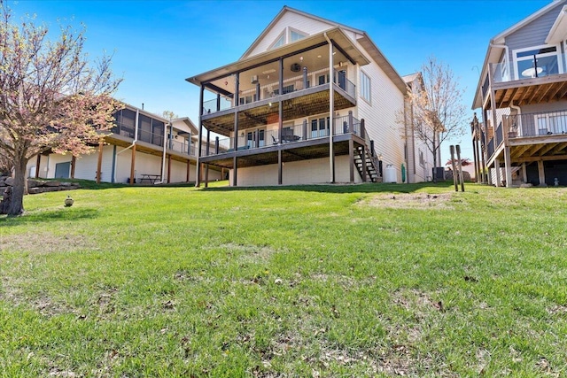 500 Navajo Trl, Kimberling City, MO 65686 - rear view of house featuring central AC, a lawn, and stairs