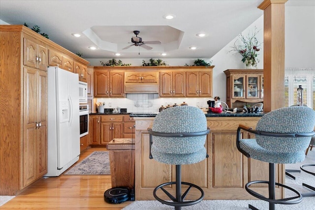500 Navajo Trl, Kimberling City, MO 65686 - kitchen with recessed lighting, white appliances, light wood-style floors, a tray ceiling, and ceiling fan