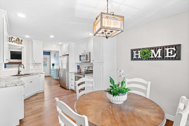 704 E Waterford Blvd, Ozark, MO 65721 - dining space with decorative columns, recessed lighting, light wood-style flooring, and baseboards