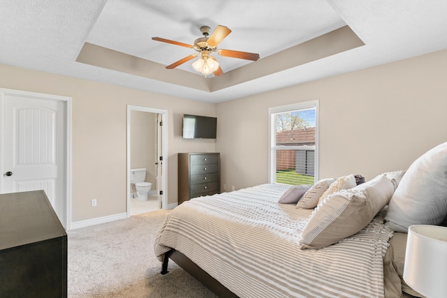 704 E Waterford Blvd, Ozark, MO 65721 - bedroom with baseboards, a raised ceiling, ensuite bathroom, ceiling fan, and carpet
