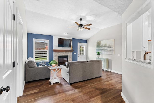 704 E Waterford Blvd, Ozark, MO 65721 - living area featuring ceiling fan, a wealth of natural light, a fireplace, and dark wood finished floors