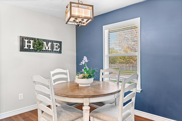 704 E Waterford Blvd, Ozark, MO 65721 - dining room with baseboards, a chandelier, and wood finished floors