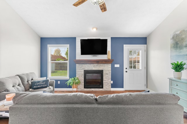 704 E Waterford Blvd, Ozark, MO 65721 - living room featuring a large fireplace, ceiling fan, a wealth of natural light, and wood finished floors