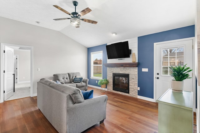 704 E Waterford Blvd, Ozark, MO 65721 - living room with a stone fireplace, baseboards, ceiling fan, lofted ceiling, and wood finished floors