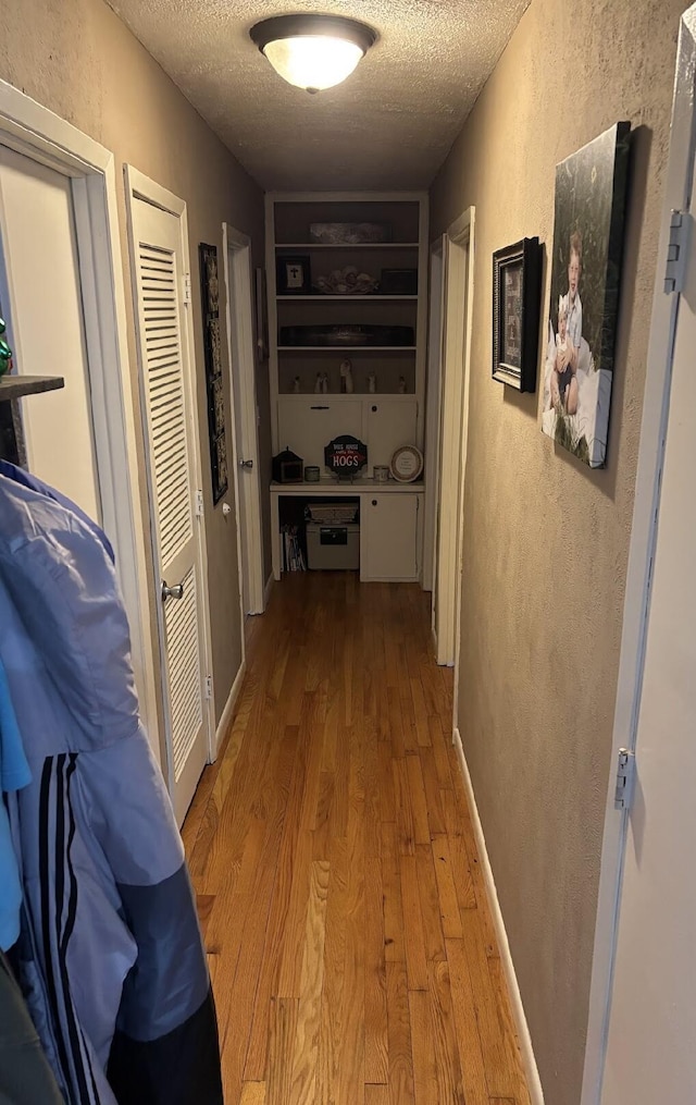 85 Peggy Ave, Mammoth Spring, AR 72554 - corridor with a textured ceiling, a textured wall, and wood finished floors