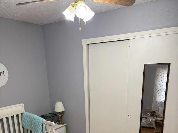 85 Peggy Ave, Mammoth Spring, AR 72554 - bedroom with a textured ceiling, a closet, and ceiling fan