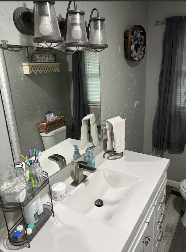 85 Peggy Ave, Mammoth Spring, AR 72554 - bathroom with a textured wall, wood finished floors, and vanity