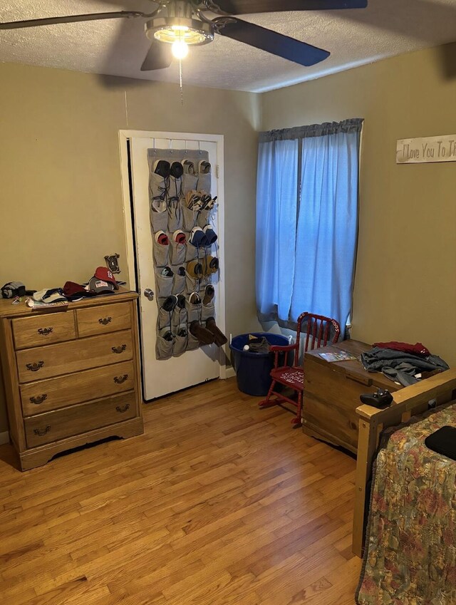 85 Peggy Ave, Mammoth Spring, AR 72554 - bedroom featuring light wood-style flooring, a textured ceiling, and ceiling fan