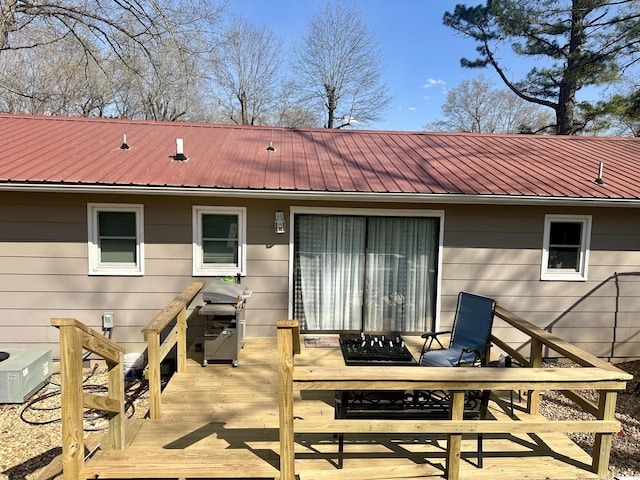 85 Peggy Ave, Mammoth Spring, AR 72554 - rear view of property featuring a deck and a metal roof