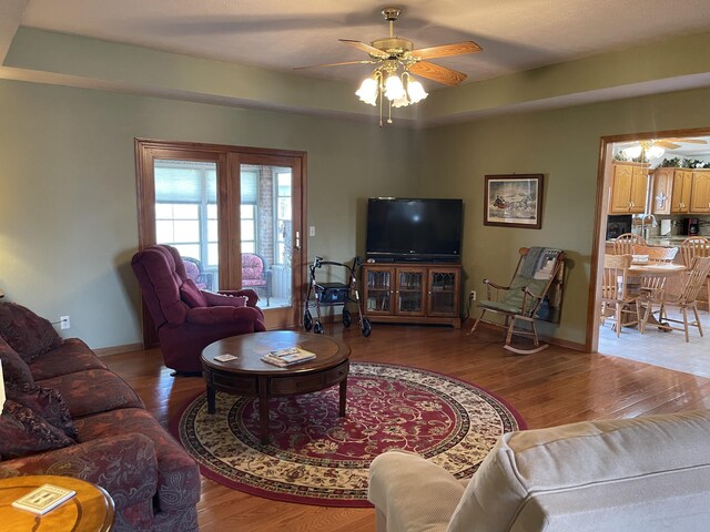1605 S Meadow Ln, Bolivar, MO 65613 - living room featuring ceiling fan, wood finished floors, and baseboards