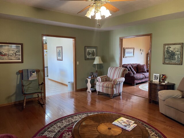 1605 S Meadow Ln, Bolivar, MO 65613 - living room with wood-type flooring, baseboards, and ceiling fan