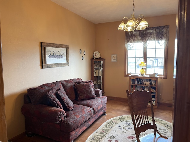 1605 S Meadow Ln, Bolivar, MO 65613 - living room with baseboards, light wood-type flooring, and a chandelier