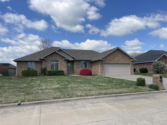 1605 S Meadow Ln, Bolivar, MO 65613 - ranch-style house with an attached garage, concrete driveway, a front lawn, and brick siding