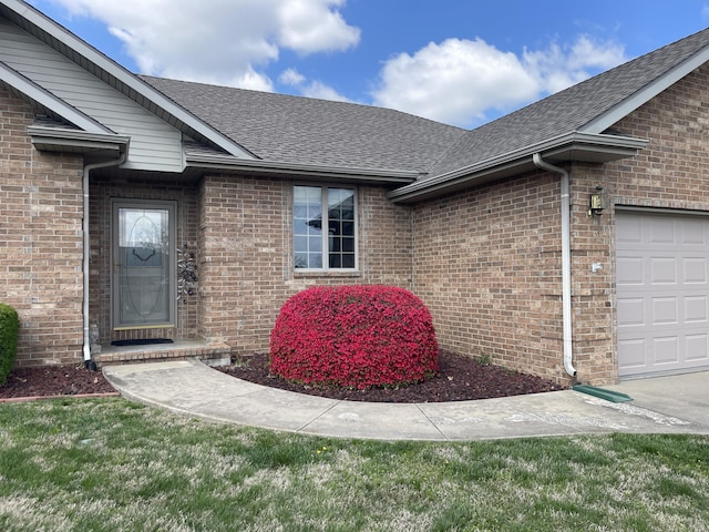 1605 S Meadow Ln, Bolivar, MO 65613 - doorway to property featuring brick siding, a shingled roof, and an attached garage