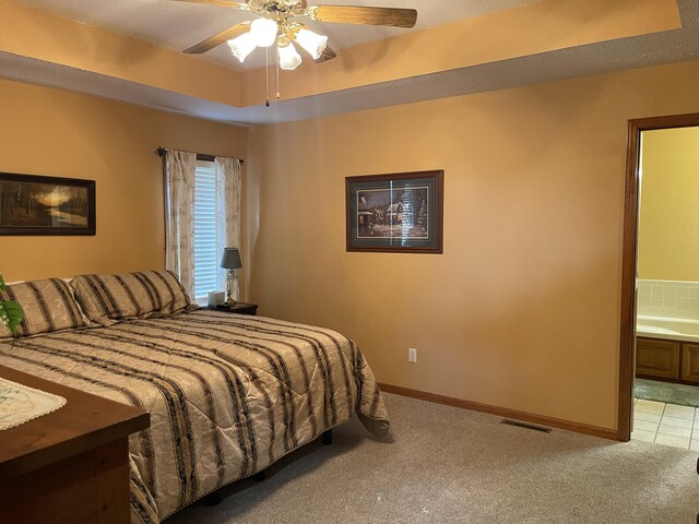 1605 S Meadow Ln, Bolivar, MO 65613 - bedroom featuring ceiling fan, light colored carpet, ensuite bath, visible vents, and baseboards